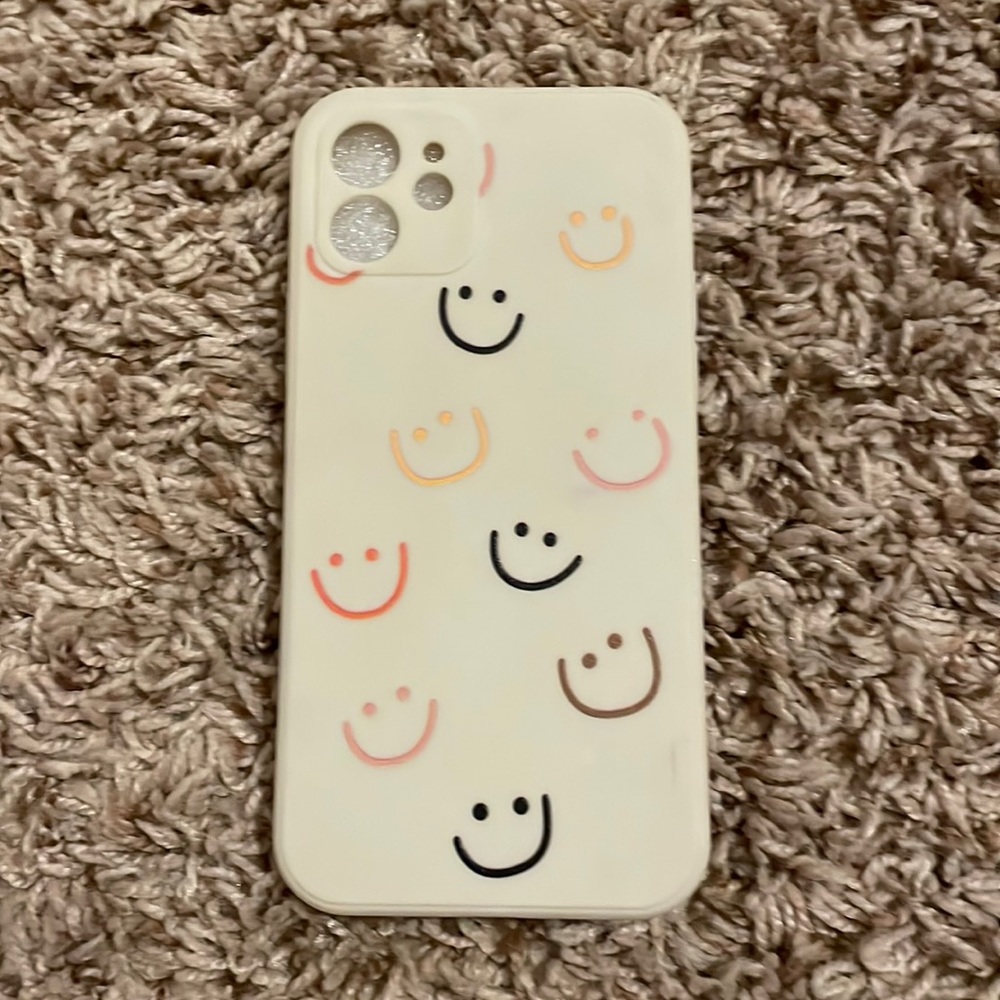 Light tan phone case with :-) is. Fits iPhone 12 regular and iPhone 12 pro.